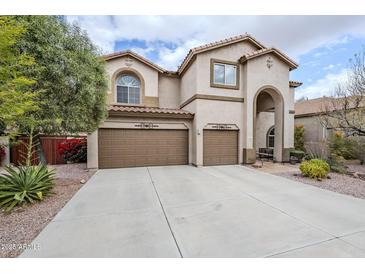 Two-story house with two-car garage and landscaped front yard at 4264 S Columbine Way, Gold Canyon, AZ 85118