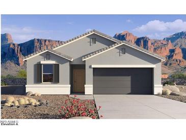 Single-story home with gray exterior, two-car garage, and desert landscaping at 9699 S Mara Dr, Apache Junction, AZ 85120