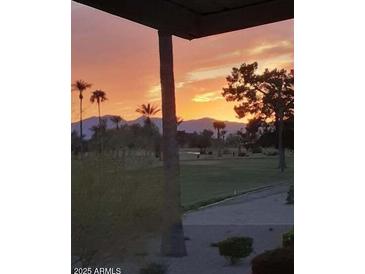 Stunning sunset over a golf course, scenic mountain backdrop at 10851 N Fairway E Ct, Sun City, AZ 85351