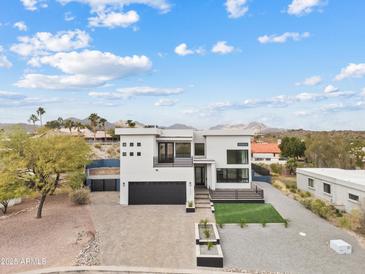 Modern two-story home with a sleek design and landscaped front yard at 15008 N Tamarack Ln, Fountain Hills, AZ 85268