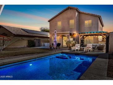 Inviting backyard with sparkling pool, pergola, and spacious patio at 15138 W Fillmore St, Goodyear, AZ 85338