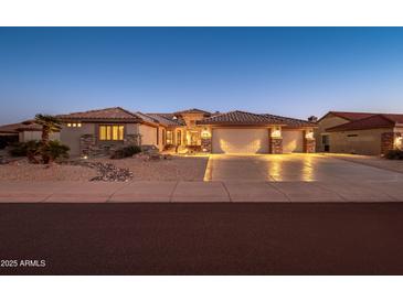 Beautiful desert home with welcoming front yard and three-car garage at 15725 W Linksview Dr, Surprise, AZ 85374