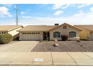 Charming single-story home featuring a tile roof, well-maintained landscaping, and an attached two-car garage at 16241 S 40Th Way, Phoenix, AZ 85048