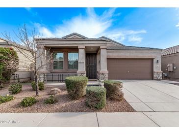 Single-story home with a brown garage door and landscaped front yard at 1631 N Beverly --, Mesa, AZ 85201