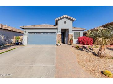 Single-story home with two-car garage and landscaped front yard at 17962 W Vogel Ave, Waddell, AZ 85355