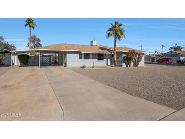 Cute ranch home with carport and spacious gravel driveway at 2008 W Campbell Ave, Phoenix, AZ 85015