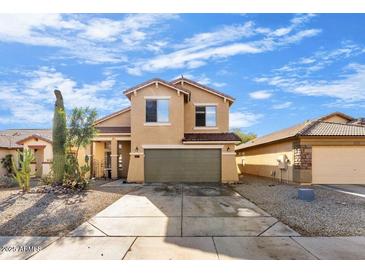 Two-story tan house with a two-car garage and desert landscaping at 2119 W Vineyard Plains Dr, San Tan Valley, AZ 85144