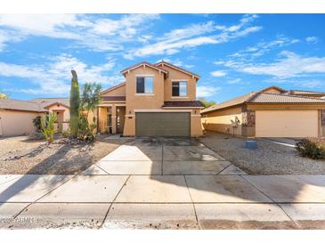 Two-story house with a green garage door and desert landscaping at 2119 W Vineyard Plains Dr, San Tan Valley, AZ 85144