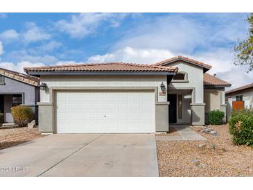 Single-story house with a two-car garage and desert landscaping at 21362 E Puesta Del Sol Rd, Queen Creek, AZ 85142