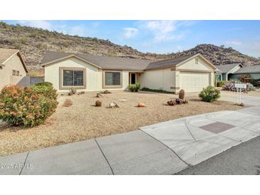 Single-story home with desert landscaping and a two-car garage at 22667 N 30Th Ave, Phoenix, AZ 85027