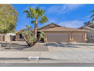 Single-story home with a three-car garage and desert landscaping at 23827 N 44Th Ln, Glendale, AZ 85310