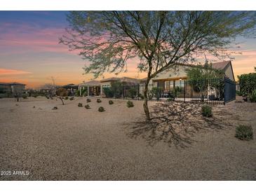 Desert landscape with fenced patio and covered seating area at 36168 N Stoneware Dr, Queen Creek, AZ 85140