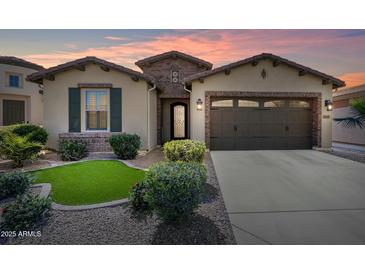 Single-story home with front yard and two-car garage at 36168 N Stoneware Dr, Queen Creek, AZ 85140