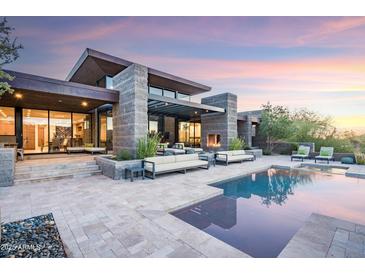 Modern home with pool and landscaped backyard; expansive patio and stunning sunset views at 38484 N 94Th St, Scottsdale, AZ 85262