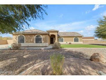 One-story house with a landscaped lawn and a large driveway at 3936 E Ascot Dr, San Tan Valley, AZ 85140