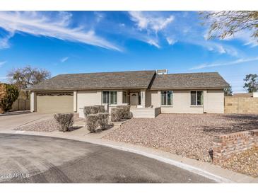 Charming single-story home with desert landscaping, neutral paint and a two-car garage at 4542 W Villa Theresa Dr, Glendale, AZ 85308