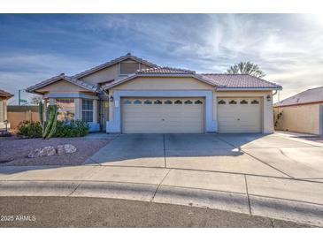 Single-story home with three-car garage and desert landscaping at 5153 W Pontiac Dr, Glendale, AZ 85308