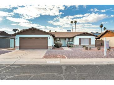 Single-story home with a two-car garage and landscaped front yard at 5331 W Mescal St, Glendale, AZ 85304