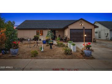 Well-maintained house with a landscaped front yard and a spacious driveway at 7215 W Mclellan Rd, Glendale, AZ 85303