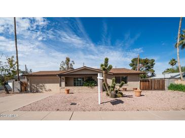 Single story home with a landscaped front yard, and two-car garage at 8514 E Fairmount Ave, Scottsdale, AZ 85251