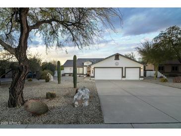 Single-story home with desert landscaping and a three-car garage at 9546 E Anasazi Pl, Gold Canyon, AZ 85118