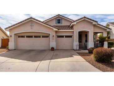 Charming single-story home featuring a two-car garage and well-maintained front yard landscaping at 1493 E Robinson Way, Chandler, AZ 85225