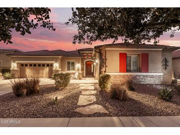 Stunning one-story home with a three-car garage and landscaped front yard at 19000 E Old Beau Trl, Queen Creek, AZ 85142