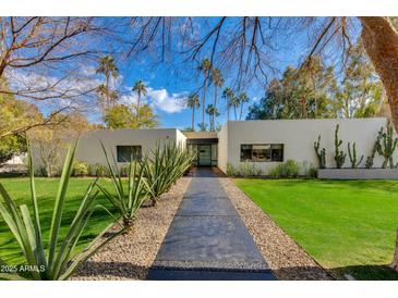 Stunning modern home with desert landscaping, manicured lawn, and blue skies at 3601 N 55Th Pl, Phoenix, AZ 85018