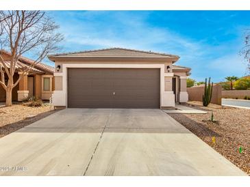 Single-story house with a two-car garage and desert landscaping at 40061 W Sanders Way, Maricopa, AZ 85138