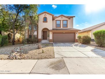 Two-story house with a large driveway and desert landscaping at 41405 W Cielo Ln, Maricopa, AZ 85138