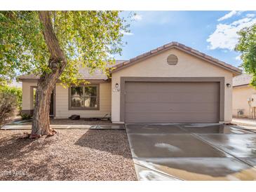 House exterior featuring a two-car garage and well-maintained landscaping at 485 W Fabens Ln, Gilbert, AZ 85233