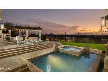 Backyard pool and spa featuring outdoor dining area with a built in grill and views of the city at 5427 E Wonderview Rd, Phoenix, AZ 85018
