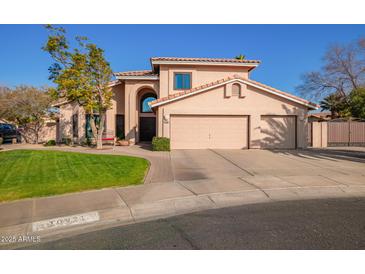 Two-story house with a two-car garage and landscaped front yard at 10921 W Bermuda Dr, Avondale, AZ 85392