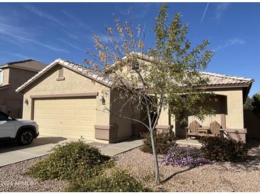 Single-story house with a two-car garage and well-maintained landscaping at 1534 E Alba Dr, Casa Grande, AZ 85122