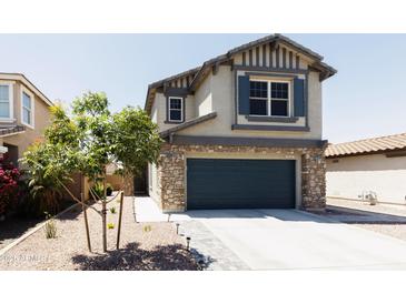 Two-story house with stone accents and a two-car garage at 18147 W Lundberg St, Surprise, AZ 85388