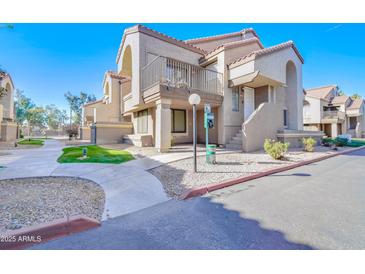 Condo building exterior with walkway and landscaping at 1905 E University Dr # 207, Tempe, AZ 85288