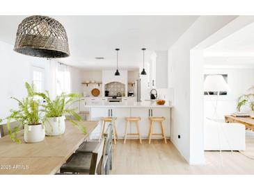 Bright white kitchen with island, stainless steel appliances, and stylish backsplash at 2816 E Cholla St, Phoenix, AZ 85028