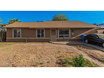 Ranch-style home with a spacious yard and driveway at 2817 W Marshall Ave, Phoenix, AZ 85017