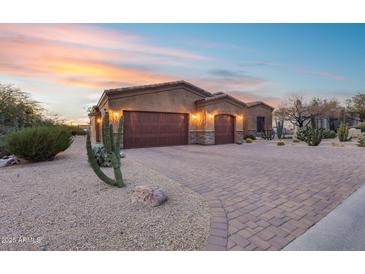 Stunning desert landscape surrounds this single-story home with a three-car garage at 28370 N 113Th Way, Scottsdale, AZ 85262