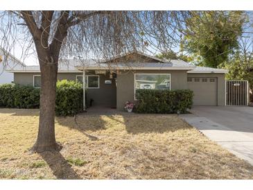 Charming single story home with attached garage and well-manicured lawn at 4305 E Earll Dr, Phoenix, AZ 85018