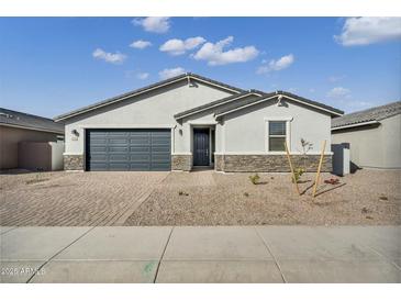 Charming single-story home featuring a gray color scheme, stone accents, and a well-maintained front yard at 5030 W Hunter Trl, San Tan Valley, AZ 85144