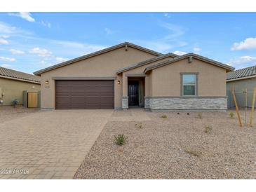 Single-story house with brown garage door and stone accents at 5030 W Hunter Trl, San Tan Valley, AZ 85144