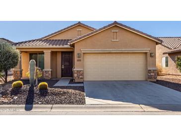 Single-story house with desert landscaping and a two-car garage at 5219 W Buckskin Dr, Eloy, AZ 85131