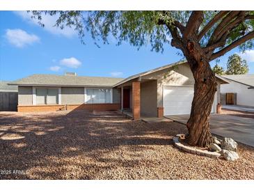 Single-story home with a two-car garage and a landscaped front yard at 527 N Valencia Pl, Chandler, AZ 85226