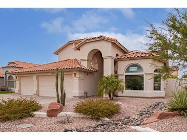 Two-story home with tile roof, two-car garage, and desert landscaping at 9144 E Pershing Ave, Scottsdale, AZ 85260