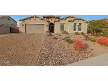 Single-story home with a two-car garage and well-manicured landscaping at 9184 W Donald Dr, Peoria, AZ 85383