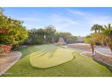 Putting green, hot tub, and desert landscaping in backyard at 2023 E Fawn Dr, Phoenix, AZ 85042