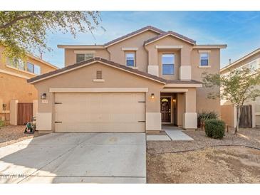 Two-story home featuring a tan exterior, a two-car garage, and manicured landscaping at 2159 S Luther --, Mesa, AZ 85209