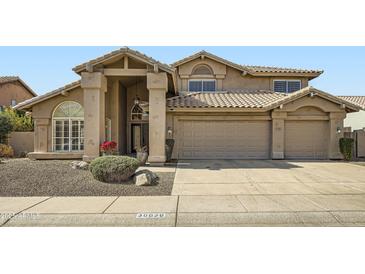 Inviting home featuring a tile roof, grand entryway, and a spacious three-car garage at 30626 N 45Th Pl, Cave Creek, AZ 85331