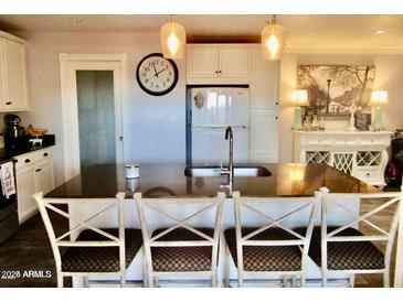 Modern kitchen with island, white cabinets, and granite countertops at 5154 N 83Rd St, Scottsdale, AZ 85250